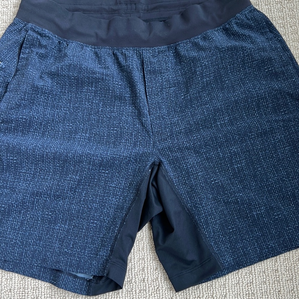 XL lululemon shorts. Old school but in good condition. Black and blue w/ zipper.